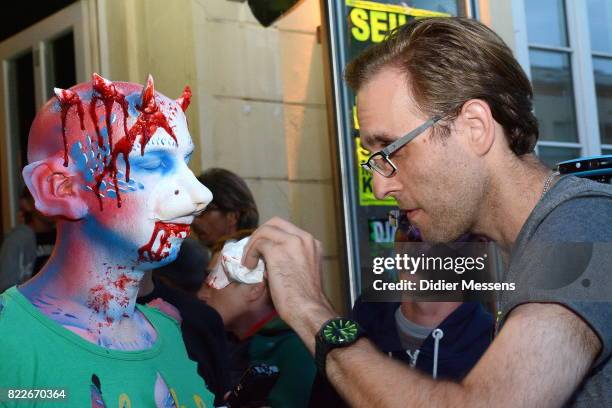 Models are getting make-up to paticipate in the Zombie walk at the 20th world bodypainting festival on July 25, 2017 in Klagenfurt, Austria.