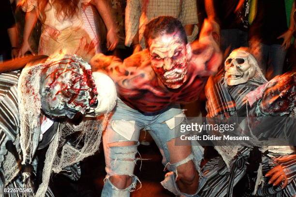 Participants dressed and made up as zombies take part in the Zombie walk as part of the 20th world bodypaint festival on July 25, 2017 in Klagenfurt,...