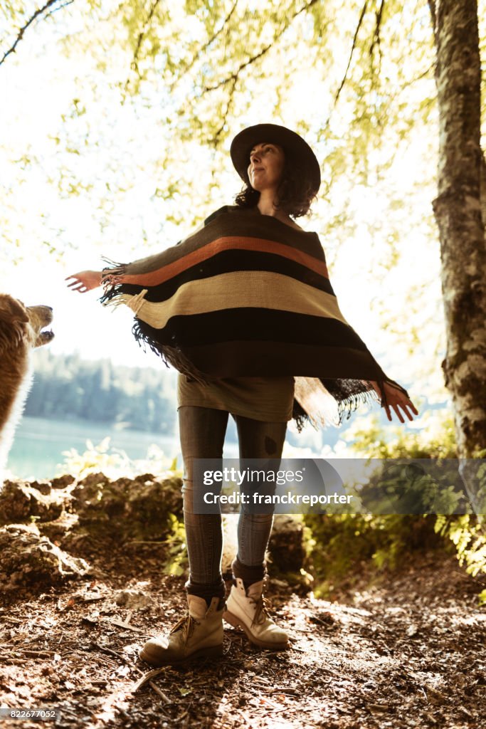 Woman playing with the dog in the mountain