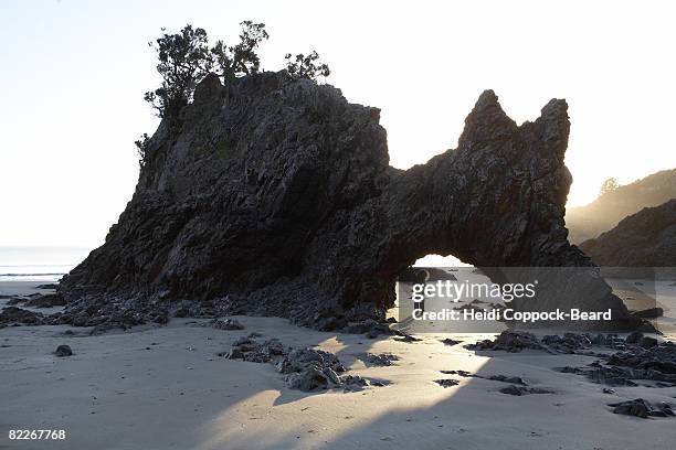 child under rock formation by the sea - heidi coppock beard stock pictures, royalty-free photos & images