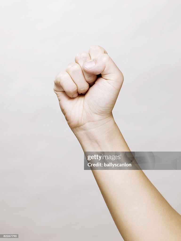 Woman's hand making a clinched fist