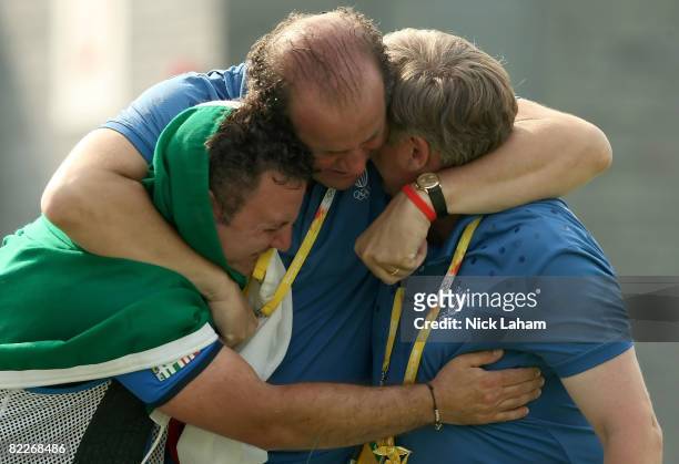 Francesco D'Aniello, Luciano Rossi and Mirco Cenci of Italy celebrate D'Aniello winning the silver medal in the men's double trap held at the Beijing...