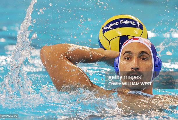 Croatia's Pavo Markovic prepares to throw the ball past Serbia's defenders during their men's preliminary roung group B water polo match at the 2008...