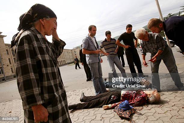 Woman reacts to two dead bodies after they were hit by a Russian shell in Stalin square, on August 12, 2008 in Gori, Georgia. Russian President...