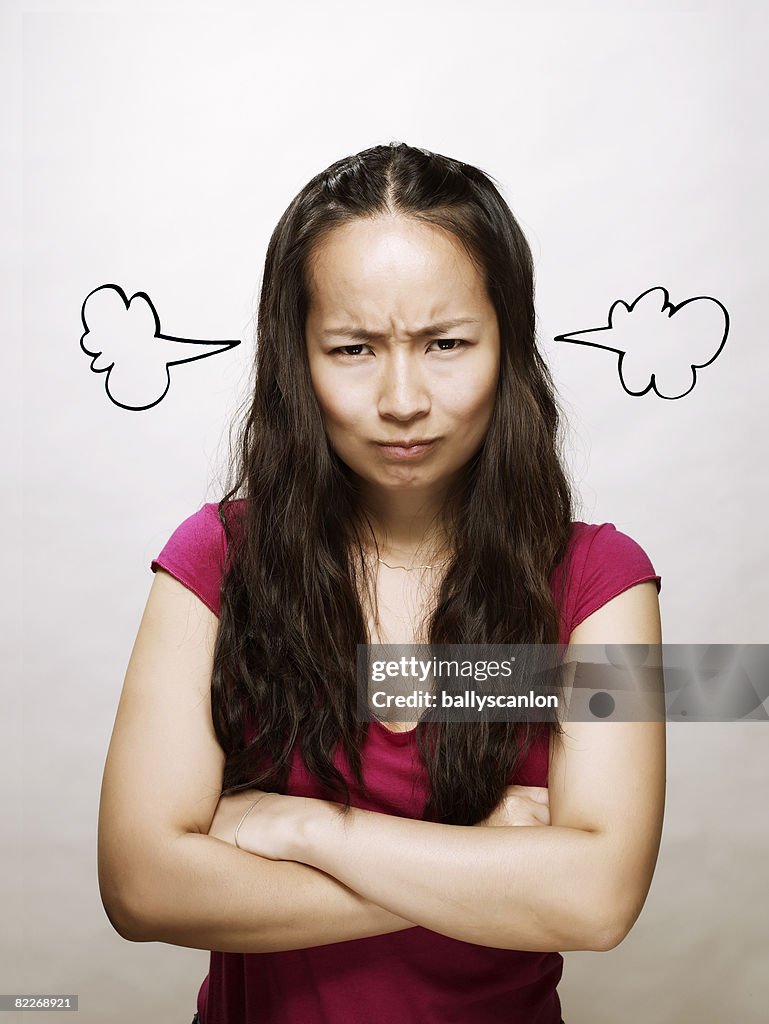 Young asian woman with steam coming out her ears