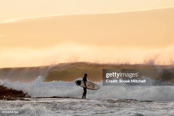 Surfer waits to paddle out at Tammaramma on July 26, 2017 in Sydney, Australia. Sydney is on track to have its warmest winter weekend in 27 years,...