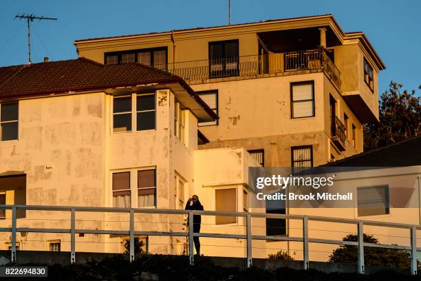 Woman takes a picture of the sunrise at Tammaramma on July 26, 2017 in Sydney, Australia. Sydney is on track to have its warmest winter weekend in 27...