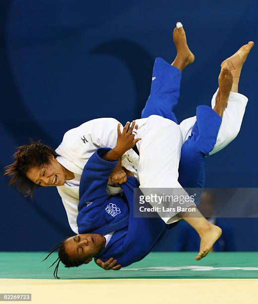 Ayumi Tanimoto of Japan throws Lucie Decosse of France in the gold medal contest of the 63kg judo bout at the Beijing Science and Technology...