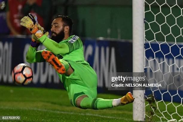 The goalkeeper of Brazil's Chapecoense, Jandrei, stops the shot by Argentina's Defensa y Justicia player Mariano Bareiro during the penalty shoot-out...