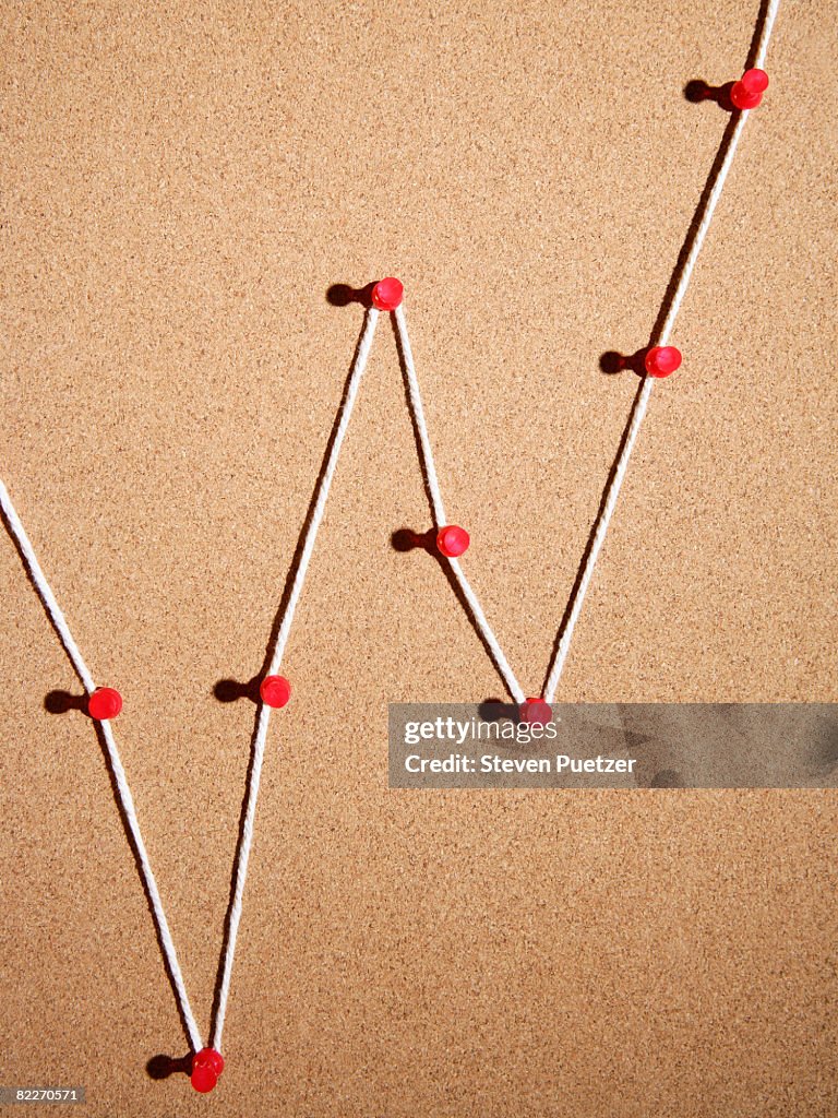 Push pins and string on cork board