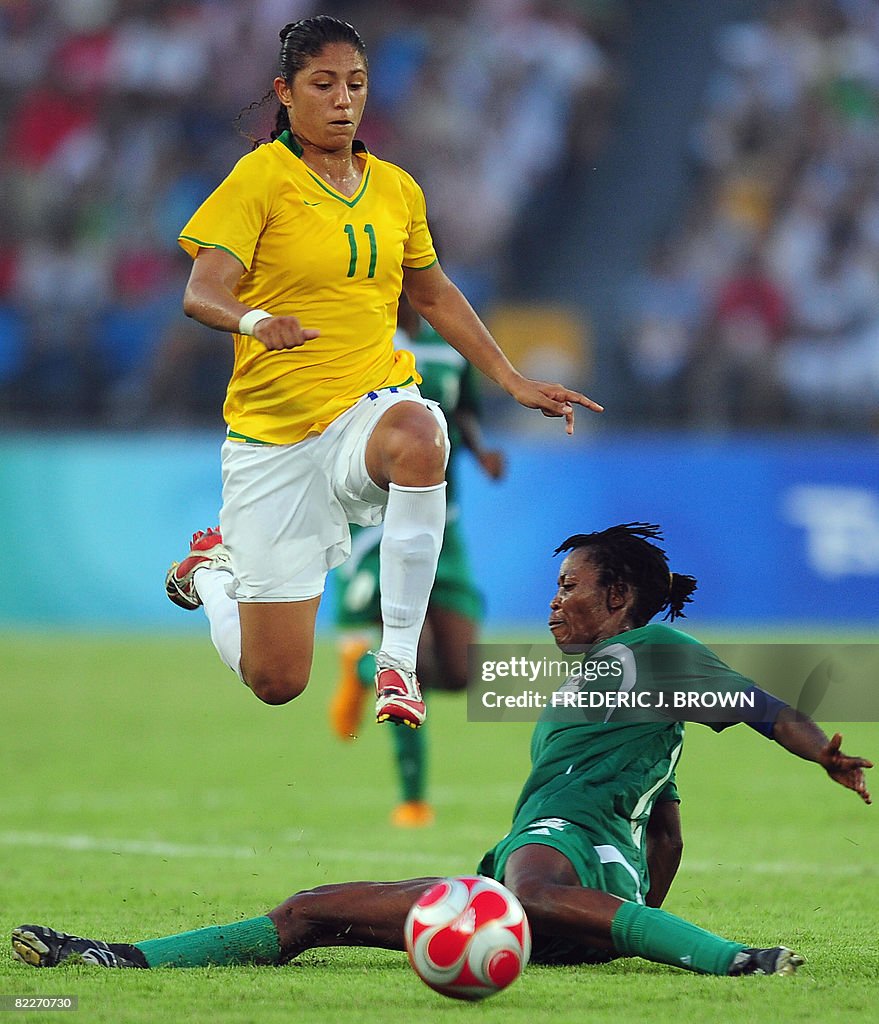 Brazil's Christiane (L) leaps over Niger