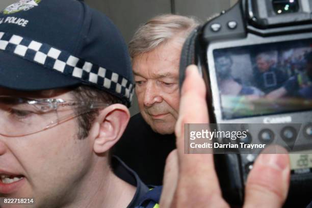 Cardinal George Pell leaves the Melbourne Magistrates Court with a heavy police guard in Melbourne on July 26, 2017 in Melbourne, Australia. Cardinal...