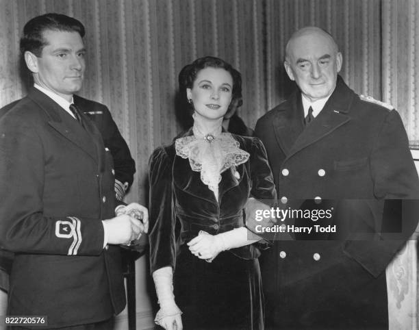 British actress Vivien Leigh and her husband, actor Laurence Olivier, of the Fleet Air Arm, with Sir Dudley Pound, the First Sea Lord at a charity...