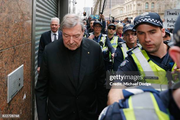 Cardinal George Pell walks with a heavy Police guard from the Melbourne Magistrates' Court on July 26, 2017 in Melbourne, Australia. Cardinal Pell...