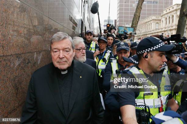 Cardinal George Pell walks with a heavy Police guard from the Melbourne Magistrates' Court on July 26, 2017 in Melbourne, Australia. Cardinal Pell...