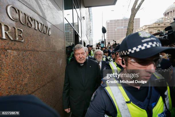 Cardinal George Pell walks with a heavy Police guard from the Melbourne Magistrates' Court on July 26, 2017 in Melbourne, Australia. Cardinal Pell...