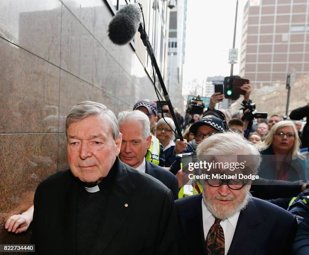 Cardinal George Pell walks with a heavy Police guard from the Melbourne Magistrates' Court on July 26, 2017 in Melbourne, Australia. Cardinal Pell...