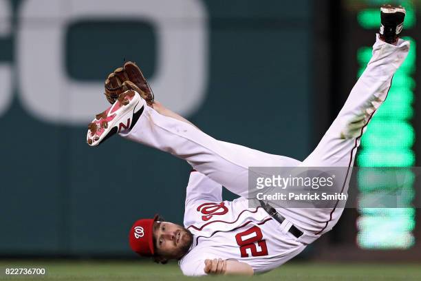 Daniel Murphy of the Washington Nationals cannot make a play to second base against the Milwaukee Brewers during the fourth inning at Nationals Park...