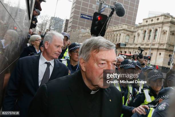 Cardinal George Pell walks with a heavy Police guard from the Melbourne Magistrates' Court on July 26, 2017 in Melbourne, Australia. Cardinal Pell...