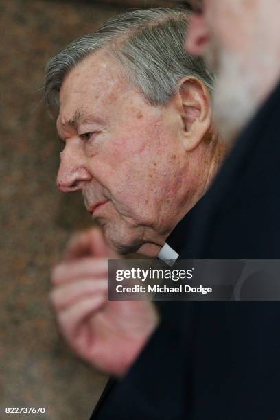 Cardinal George Pell walks with a heavy Police guard from the Melbourne Magistrates' Court on July 26, 2017 in Melbourne, Australia. Cardinal Pell...