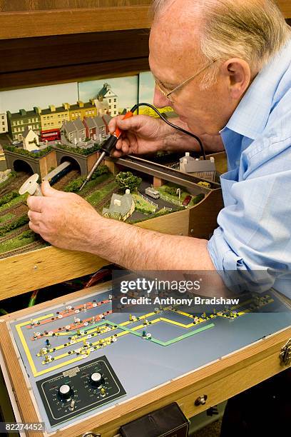 senior builds model railway - man with train set stock pictures, royalty-free photos & images