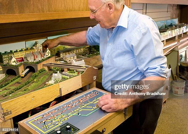 senior operates model railway - model train stock pictures, royalty-free photos & images