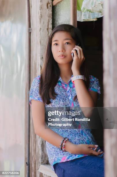 teenage girl by the window - luisiana 個照片及圖片檔