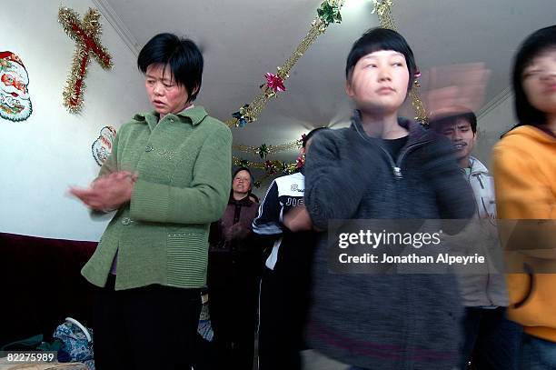 Local members of the house church are taking part of a 4 hour service inside a secret location, on March 23, 2008 in Beijing, China. Each one of...