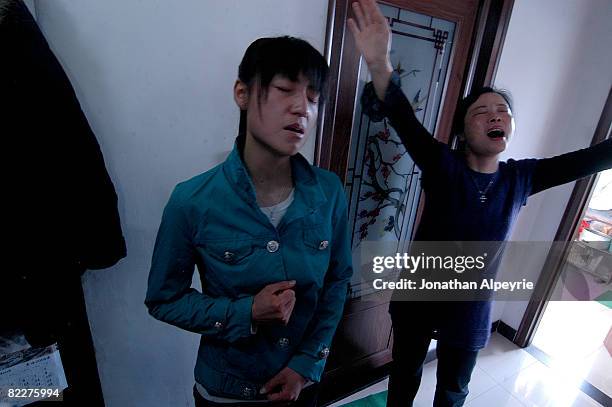 The owners of the apartment where the sunday service takes place pray out loud on March 23, 2008 in Beijing, China. These believers devote their...