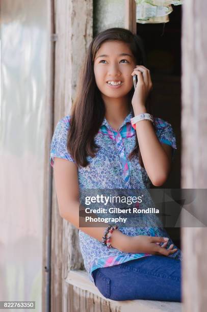 teenage girl by the window - luisiana photos et images de collection