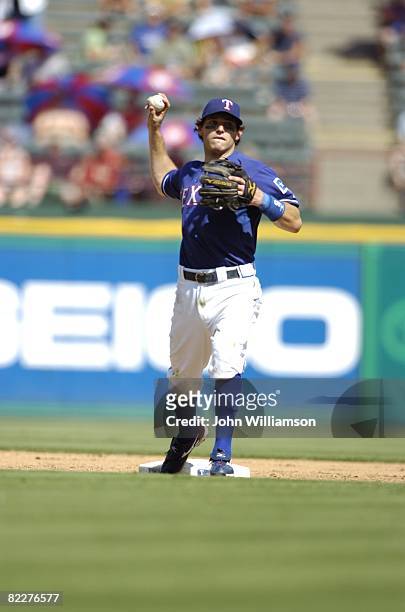 Second baseman Ian Kinsler of the Texas Rangers throws to first base after fielding a ground ball during the game against the Chicago White Sox at...