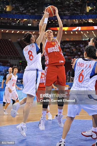 Irina Osipova of Russia shoots against Jong Ae Lee of Korea during day 3 of the women's preliminary basketball game at the 2008 Beijing Olympic Games...