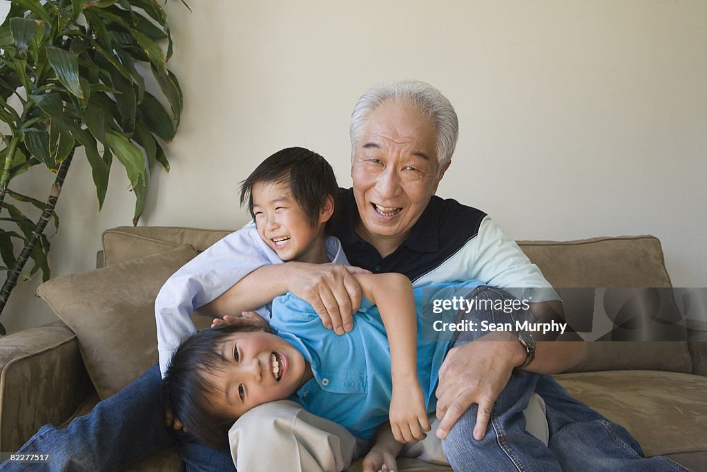 Grandfather playing with two grandso
