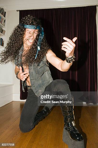 male heavy metal musician playing air guitar - heavy metal stock-fotos und bilder