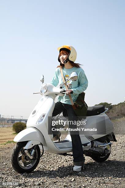 japanese woman sitting on motorbike - atsushi yamada stock pictures, royalty-free photos & images