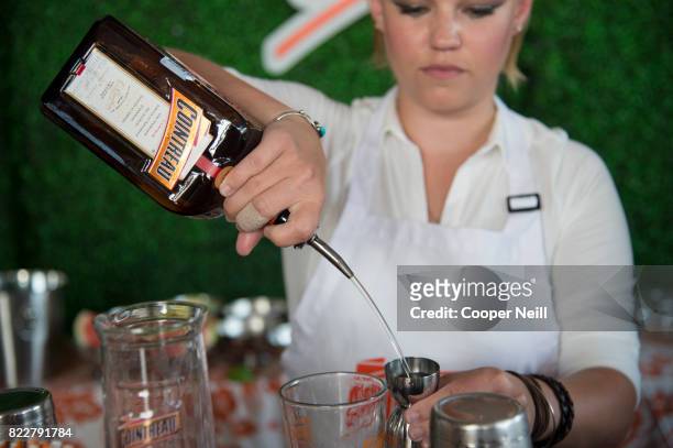 The bartender makes a drink during the Cointreau Celebrates the Original Margarita and the Art of La Soiree with Caroline Harper Knapp at DEC on...