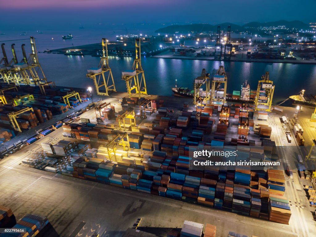 Port shipping Use crane lifting containers in ship break-bulk carrier by sea at Night of Thailand .