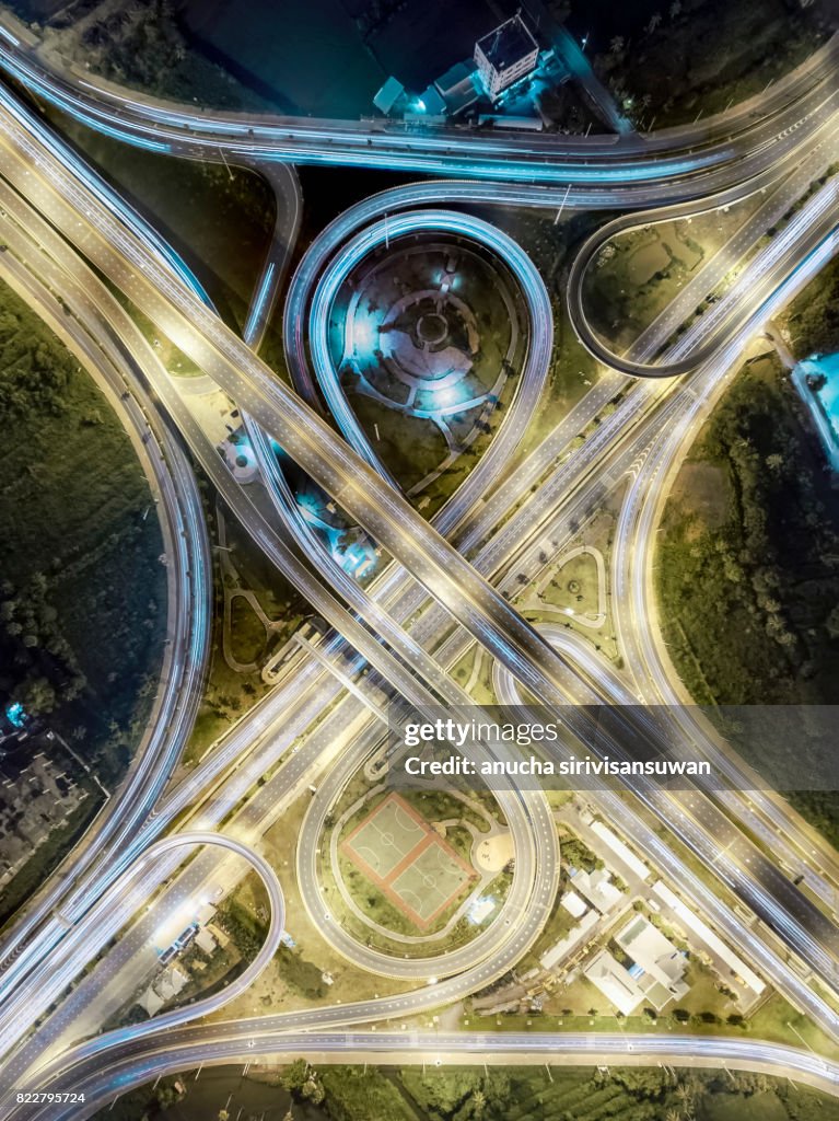 Aerial view roundabout road have public park at night , top view , thailand .