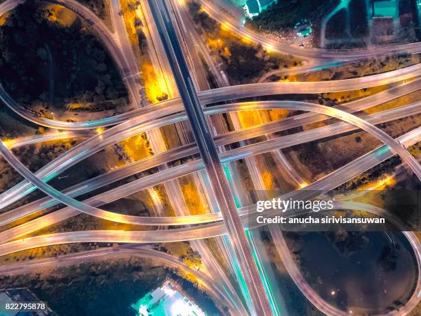 interchange highway traffic beautiful at night, bird eye view in bangkok , top view , bangkok , thailand . - road reflector stock pictures, royalty-free photos & images