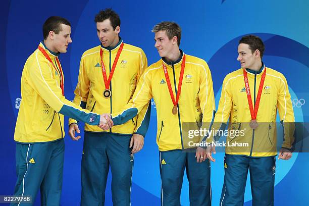 Patrick Murphy, Grant Hackett, Grant Britsand Nick Ffrost of Australia pose with the bronze medal on the podium during the medal ceremony for the...