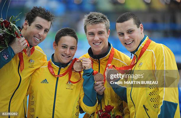 Australia's Grant Hackett, Nick Frost, Grant Brits and Patrick Murphy pose with their bronze medal after the men's 4 x 200m freestyle relay swimming...