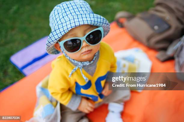 picnic on the grass - baby sunglasses stock pictures, royalty-free photos & images