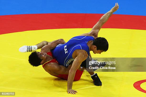 Darkhan Bayakhmetov of Kazakhstan is thrown by Li Yanyan of China in the Men's Greco-Roman 66kg quarter final bout at the China Agriculture...