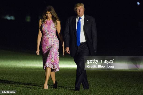 President Donald Trump and U.S. First Lady Melania Trump walk across the South Lawn of the White House in Washington, D.C., U.S., on Tuesday, July...