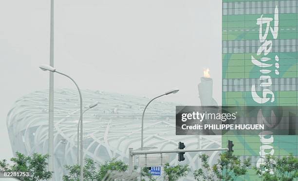 Smog is pictured over the National Stadium or 'Birds Nest' in Beijing on August 13 on day 5 of the 2008 Beijing Olympic Games. China erupted...