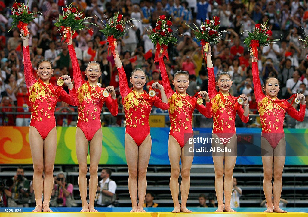 The Chinese women's gymnastics team celebrates after winning the gold