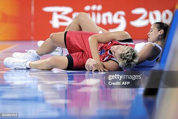 Spain's Nuria Martinez and Czech Republic's Hana Machova lie on the ground after clashing during their women's preliminary round group B basketball...