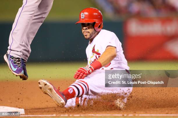 The St. Louis Cardinals' Tommy Pham slides safely into third as he takes two bases on a single by Paul DeJong in the fifth inning against the...