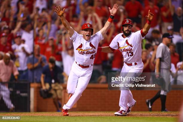 Harrison Bader and Matt Carpenter of the St. Louis Cardinals celebrate after Bader scored the game-winning run against the Colorado Rockies in the...