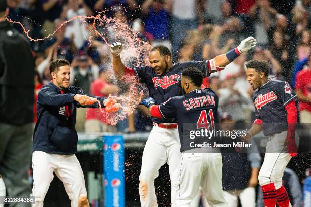 Yan Gomes, Carlos Santana and Francisco Lindor of the Cleveland Indians celebrate with Edwin Encarnacion after Encarnacion hit a walk-off grand slam...